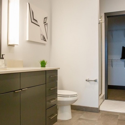 Bathroom options with thoughtful details a bathroom with a large mirror toilet and sink