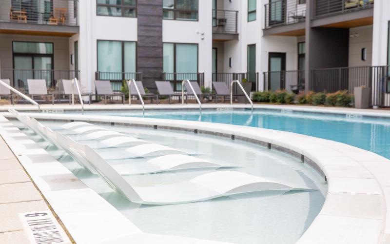 a swimming pool with chairs in it