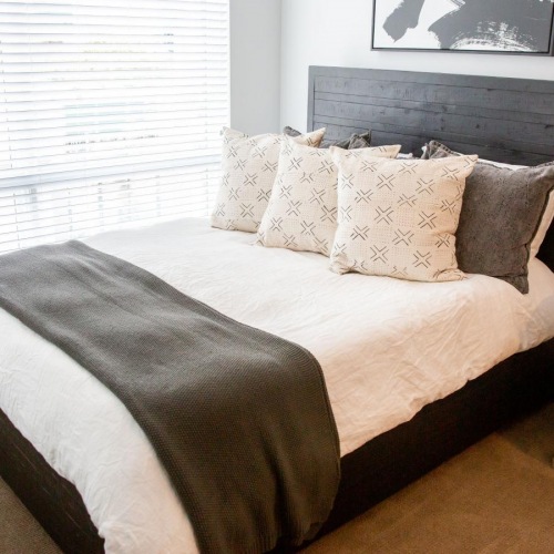 Sleep in style a bed with a blanket on it