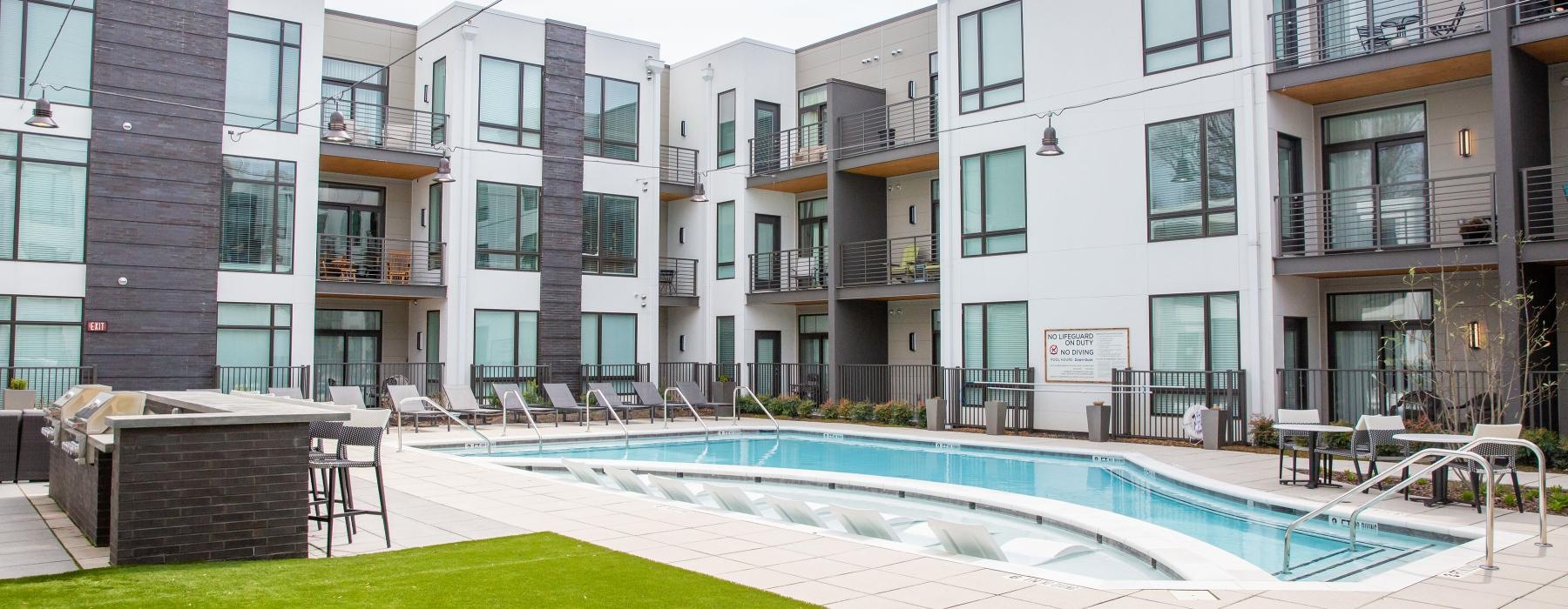 a pool in a courtyard between buildings