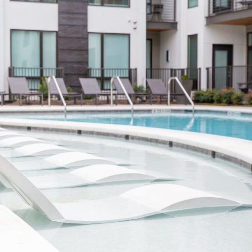 Relax and unwind poolside a swimming pool with chairs in it
